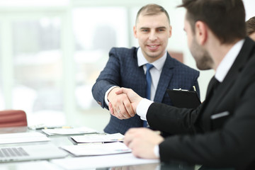 handshake trading partners at the Desk in the office