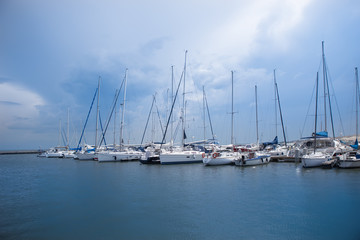 sailboats are moored on a pier