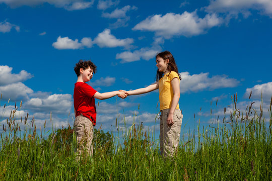 Girl and boy shaking hands 