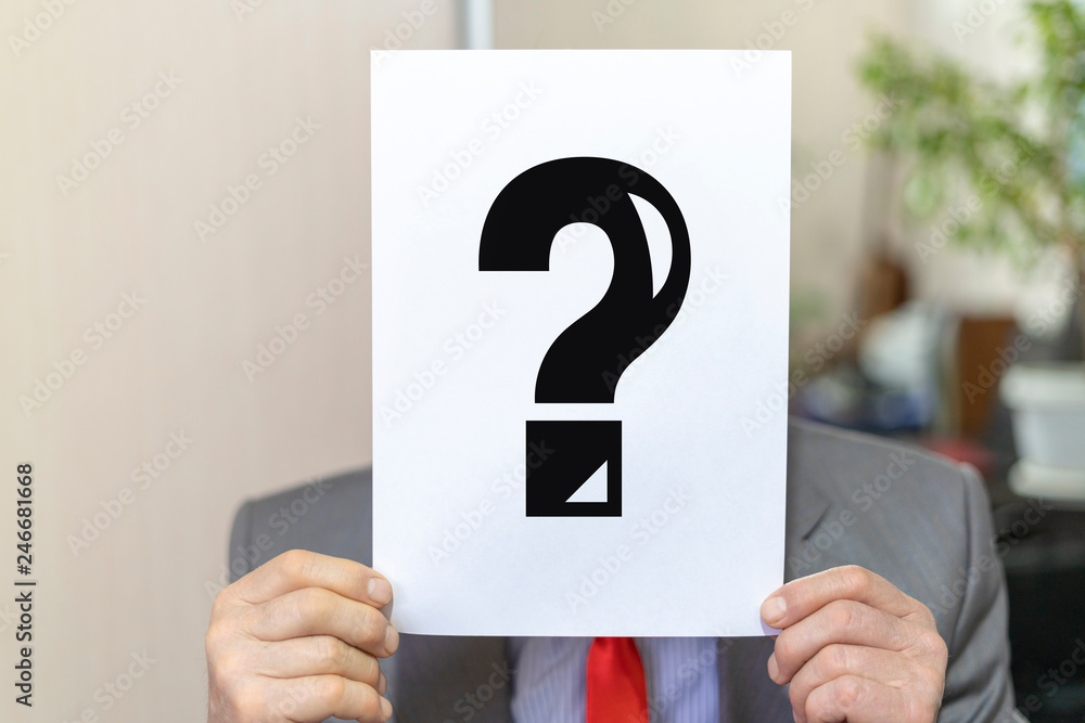 Poster anonymous businessman holding a4 signboard sheet with a question mark like a mask for hiding identit