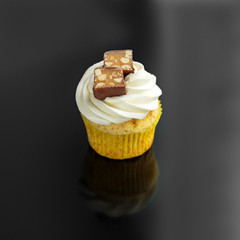 Sweet cupcake with cream and candy. The concept of food, desserts, holiday.