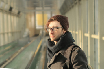 modern young man standing in the subway