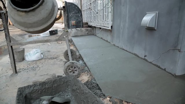 Cement mixer on construction site is mixing concrete.