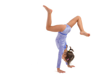 Little gymnast on a white background. Sporting exercise, stretch, flexibility, aerobics