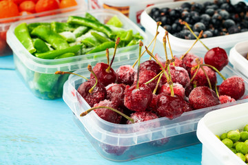 Frozen cherries and asparagus beans in plastic boxes