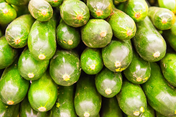 Pile of green zucchini at vegetable market