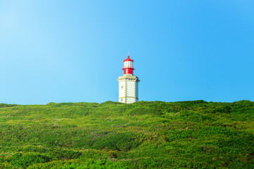 Fototapeta na wymiar lighthouse on a green hill