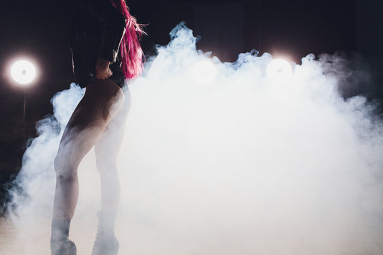 beautiful pole dancer in leather jacket on pylon.