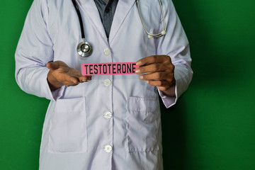 A doctor standing, Hold the Testoterone paper text on Green background. Medical and healthcare...