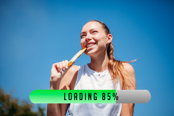 Young athletic woman is energized by a protein bar. Concept of recuperation