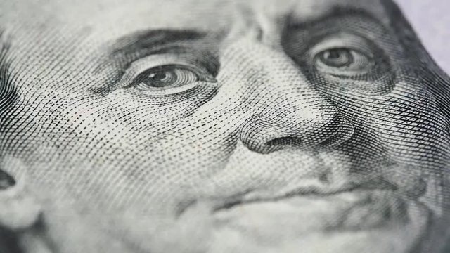 Benjamin Franklin on new US 100 dollar bill macro slow rotating. Low angle. Stock video footage