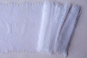 white lace on a pink background