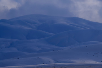 Landscape with snowy mountains in bingöl Turkey, foggy day. sunset light in snowy mountains,Perfect winter scenery at Ski area of Bingöl Karlıova