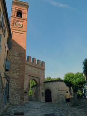 Ancient arch and clock tower in a provincial  town, Emilia Romagna province, Italy, Europe.