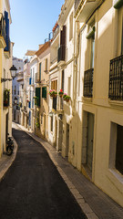 small town in Barcelona with traditional houses and flowers in the balcony and a pedestrian street at Sitges