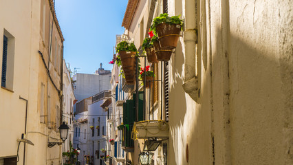 small town in Barcelona with traditional houses and flowers in the balcony and a pedestrian street at Sitges