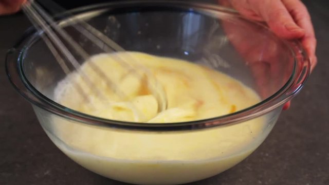 Person whisks creamy mixture