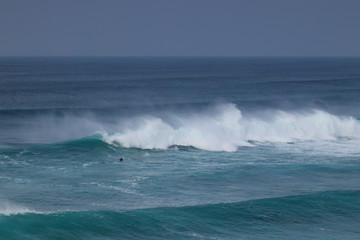 Waves crashing at the Praia Da Bordeira beach in southern Portugal in the Algarve region. Perfect and popular location for surfing. Tourist destination. 
