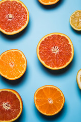 cut in half juicy citruses on a blue background