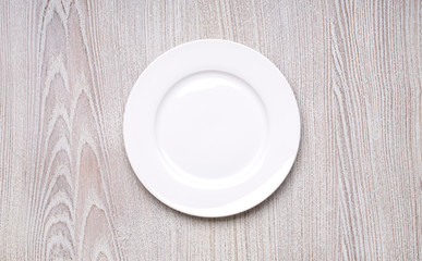 white plate on wooden table background