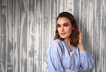 Fototapeta premium Beautiful positive young happy woman thinking and looking in casual blue shirt and short hair stye
