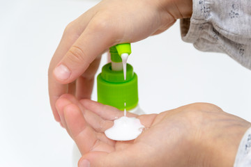 Girl's fingers press on the dispenser, cleanser, skin care product, liquid hand soap