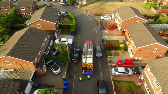 Aerial View, footage of Dustmen putting recycling waste into a garbage truck, Bin men, refuse collectors. bin lorry, Recycling day, Video No 5 of 8