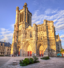 Beautiful Troyes cathedral with large clock in sunlight, France