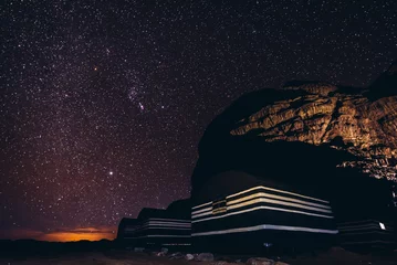 Papier Peint photo Lavable Nuit Un ciel plein d& 39 étoiles au-dessus du camp de touristes dans la vallée de Wadi Rum en Jordanie
