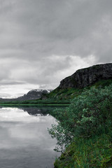 Mountain reflection in the water at the lake outside Alesjaure mountain station at the hike of Kungsleden (Kings trail) in northern Sweden. 