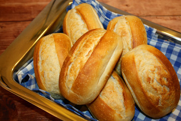 Freshly baked baguettes from the oven on wooden background.