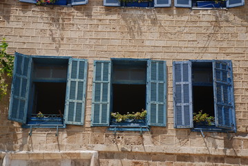 Blue wooden shutters at windows on a building in the old town of Jaffa in Tel Aviv, Israel