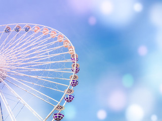 ferris wheel on the background of blue sky with colorful bright circles