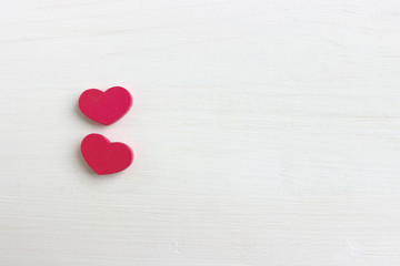 The concept of Valentine's day. Valentine's day background. Two pink hearts isolated on white wooden background. Copy space. Place for your text.