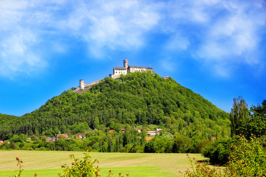 The stone castle on the hill with s blue sky