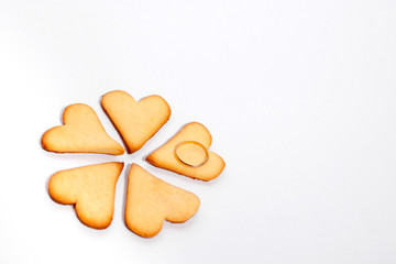 Hearts in the form of a flower with a wedding ring on a white background. Original marriage proposal. Flower from the heart.