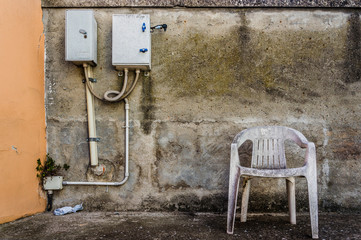 Abandoned old plastic empty chair, conceptual photo