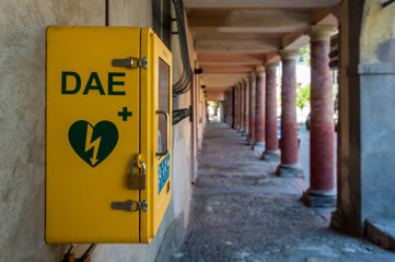 Meldola, Italy, close up of an automated external defibrillator (in italian abbreviation is DAE) place on public street - obrazy, fototapety, plakaty