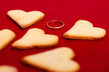 hearts with wedding ring on a red background An offer of marriage