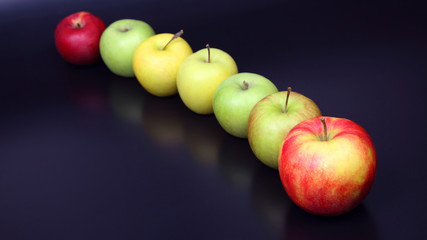 fresh different apples on dark background