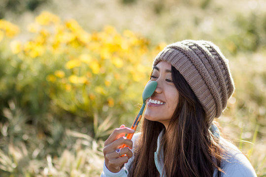 Woman smiling with a spoon on her nose