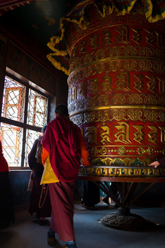 Adult holding on to Buddhist prayer wheel