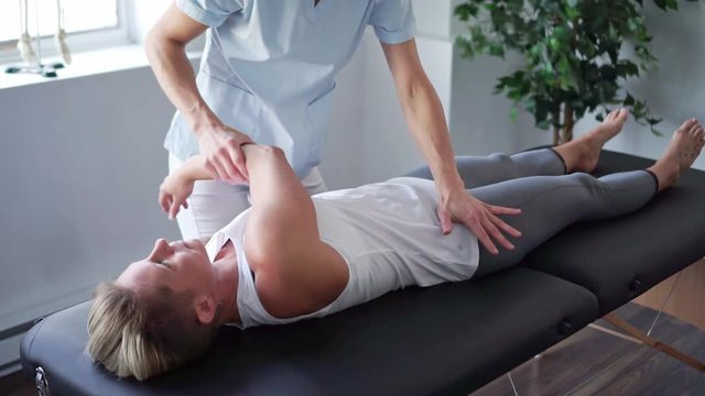 A Modern rehabilitation physiotherapy worker with woman client