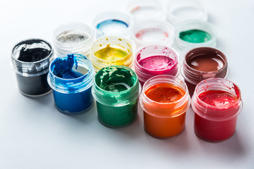 small cans of colorful gouache paint on the whole frame