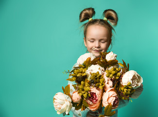 Girl holding peonies bouquet on blue background