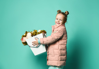 Girl holding peonies bouquet on blue background