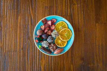 Handmade chocolates or candies and dried fruits in the plate. This is dessert plate and delicious, natural, organic luxury and healthy.