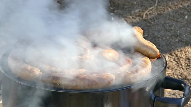 Sausages blose up outdoor on smoker aor grill