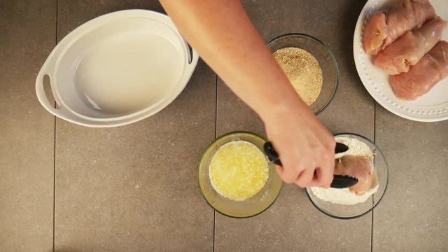 Person breads chicken cordon bleu