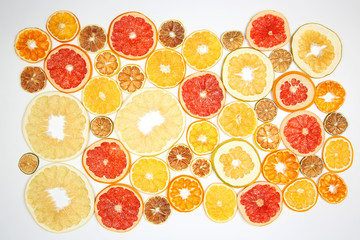 mix of different pieces of dried citrus fruit on white background